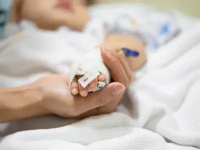 Mother holding a baby hand.